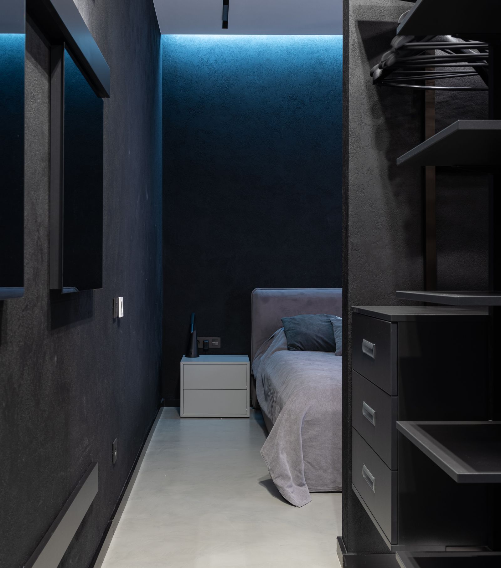 Dark walk-in closet with open shelving
