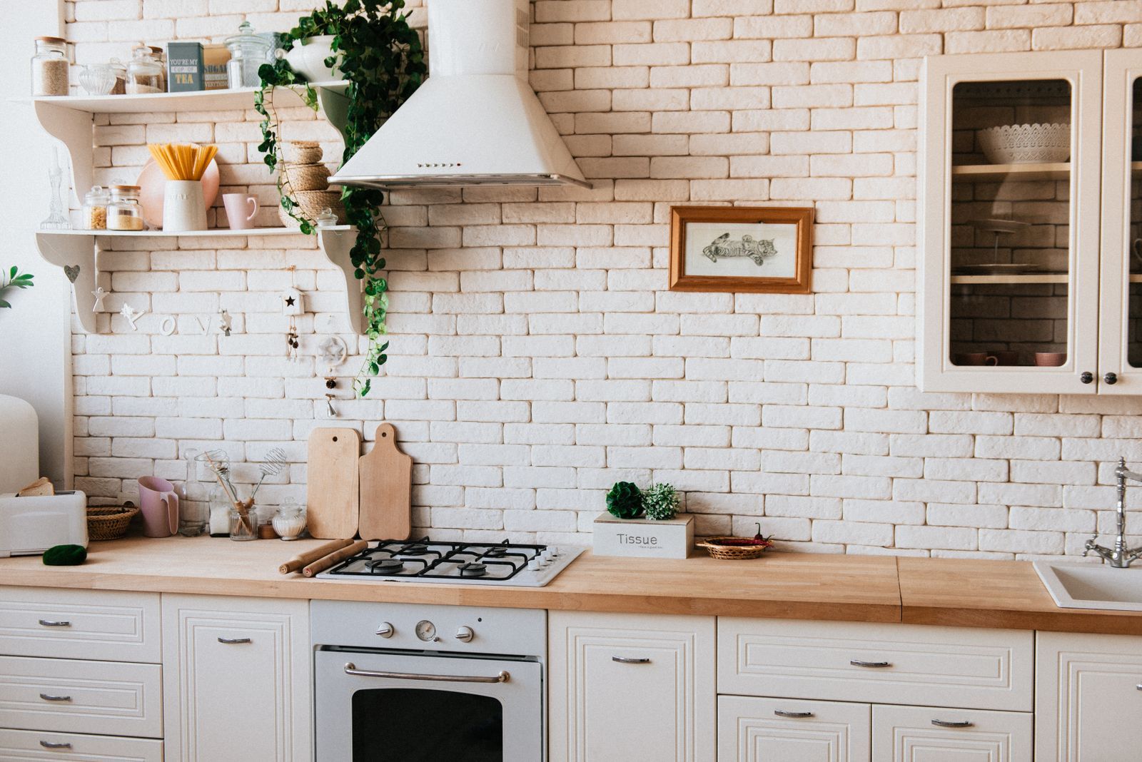 Classic kitchen with white cabinets, brick backsplash and open shelving