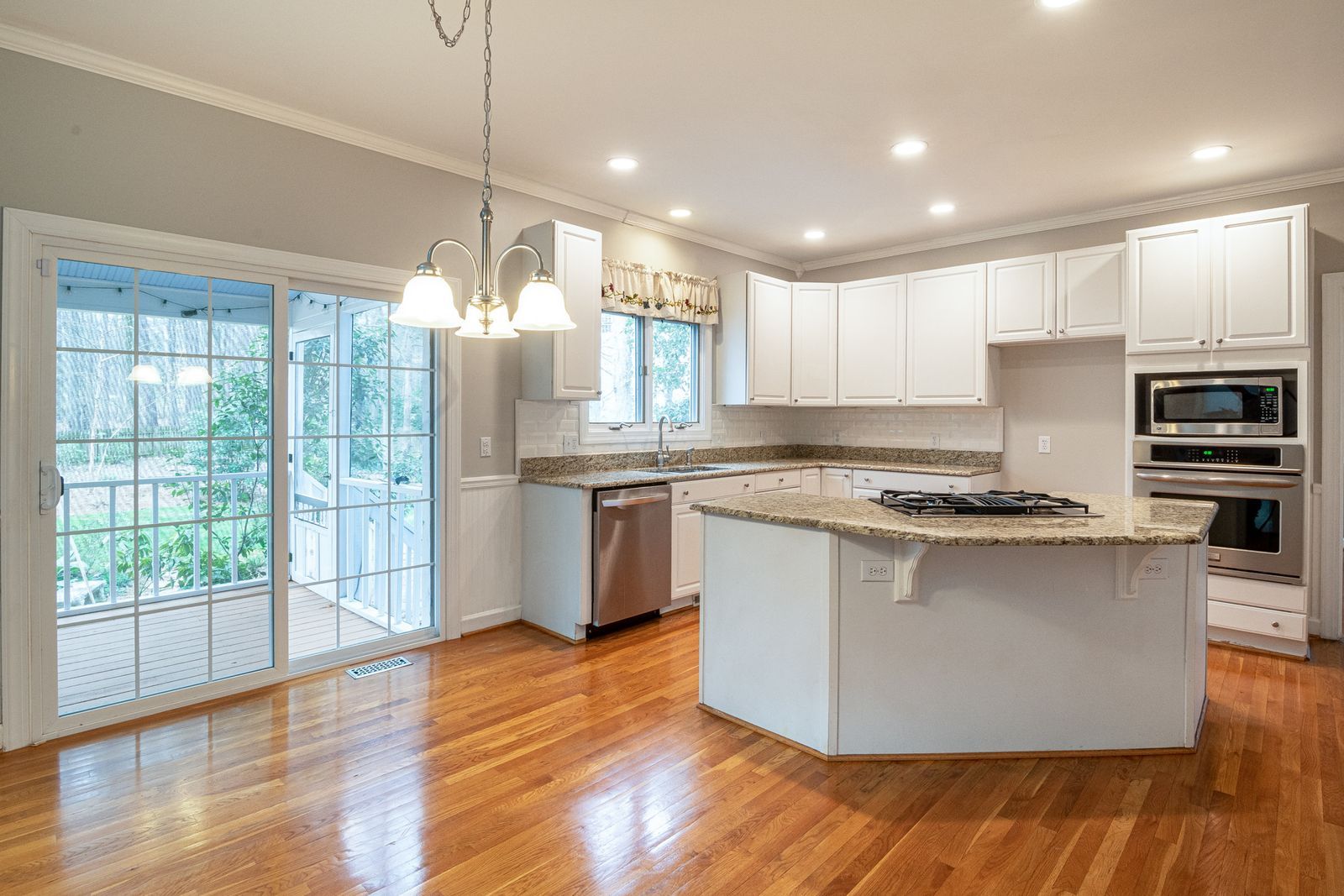 Cream traditional kitchen with raised-panel doors and a granite island