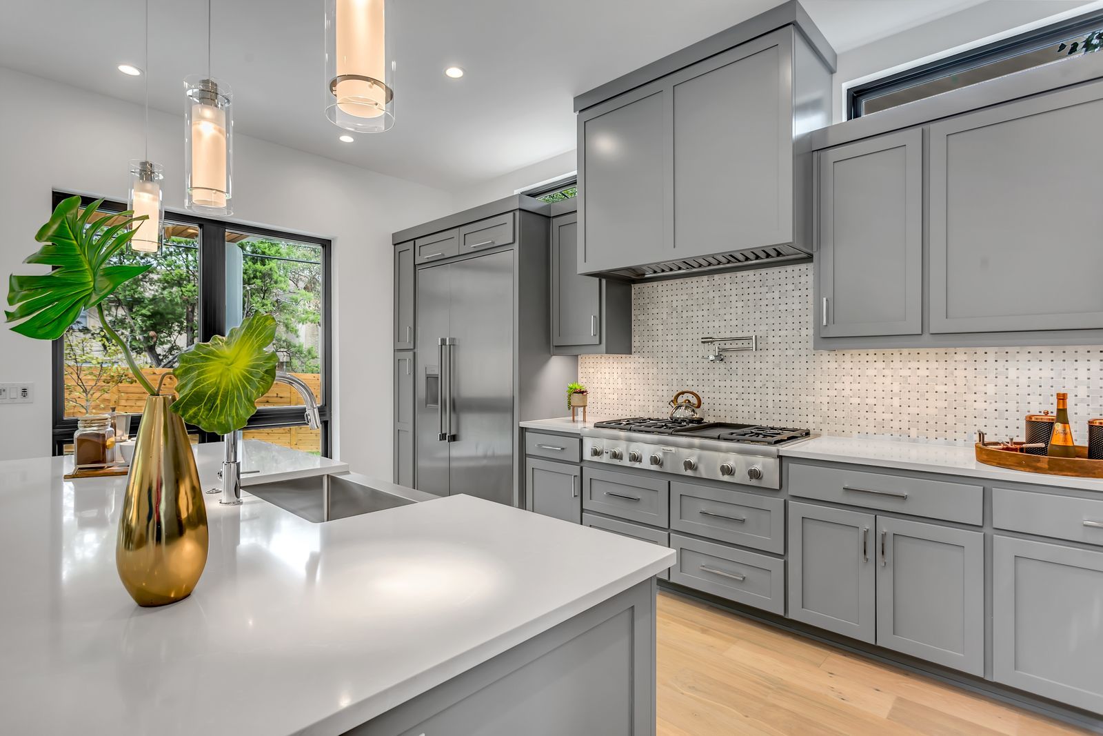 Custom grey shaker kitchen with a white quartz island